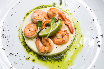 Shrimp with lime on a white plate close-up