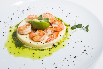 Shrimp with lime on a white plate close-up