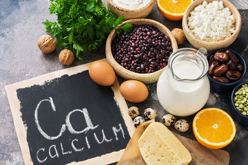 Food with calcium. A variety of foods rich in calcium. Signboard with the word-calcium. Top view.