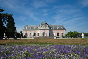 View of Schloss Benrath, old classic residence palace and small garden with white and  purple...