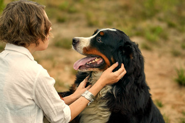 the girl hugs and strokes the dog