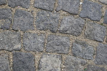 Part of road surface, paved with cobbles.