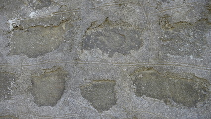 A stone wall with figures of different shapes