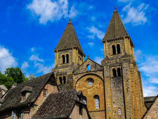 Conques medieval abbey with blue sky background, Aveyron, France