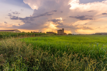 farmhouse in the countryside at sunset