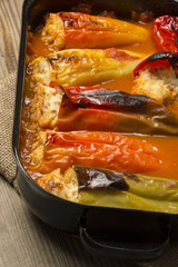 Colorful stuffed peppers with rice and meat in tomato sauce
