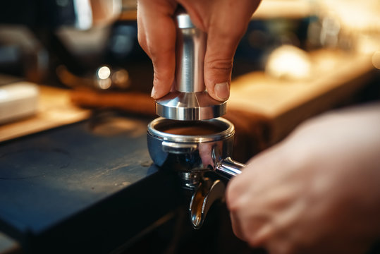 Male barista hands, fresh black coffee preparation