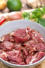 Pork medallions for Vietnamese dish preparation on a wooden board
