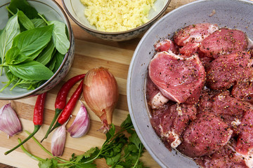 Pork medallions for Vietnamese dish preparation on a wooden board