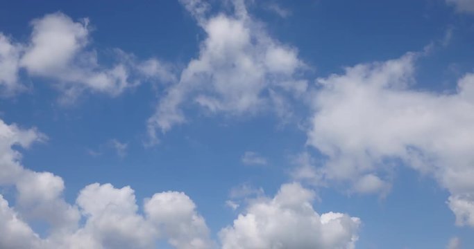 White heavy clouds fly over sky in fast motion