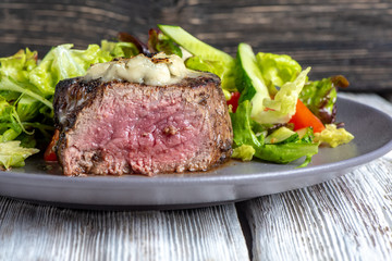 Grilled steak meat with potato gratin and vegetables