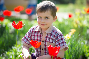 Portrait of a little boy with tulips