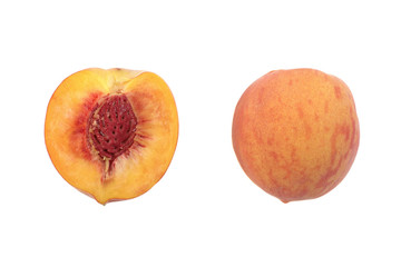 ripe juicy peach cut in half isolated on a white background