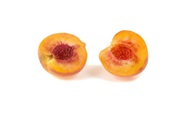 ripe juicy peach cut in half isolated on a white background
