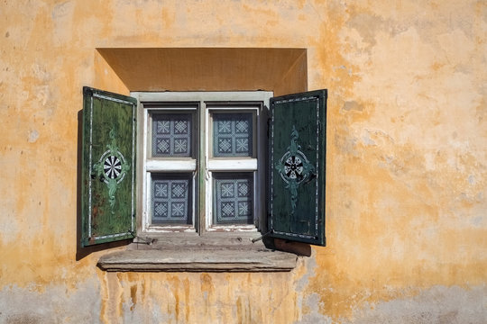 Wall and window of a nice painted and decorated brick house in Zuoz (Graubunden, Switzerland) in typical 'Engadiner' fashion. Zuoz is a municipality in the district of Maloja