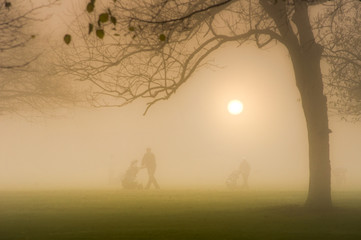 Golfers on a Foggy Sunrise