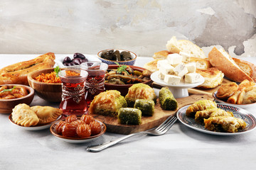 Middle eastern or arabic dishes and assorted meze, concrete rustic background. sambusak. Turkish Dessert Baklava with pistachio. Sarma. Halal food. Lebanese