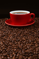 Red coffee cup with coffee beans .