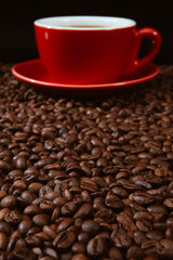 Red coffee cup with coffee beans .