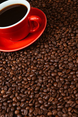 Red coffee cup with coffee beans .