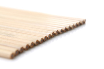 A couple of wooden pencils stacked together.
