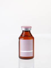 Small brown glass bottle on white background