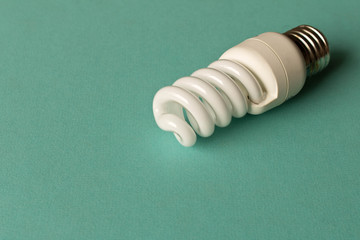 Energy-saving lamp on a light background. The concept of energy saving
