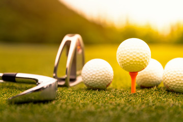  Golf balls and golf club on green grass