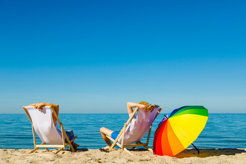Woman and man relaxing on beach