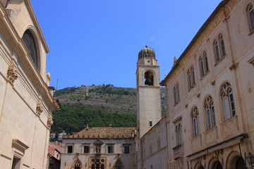 Fototapeta na wymiar Croatia - historic houses in Dubrovnik and a municipal belfry from 1444.
