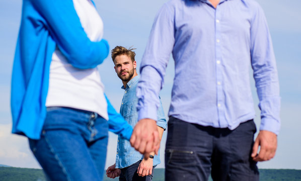 Cheating concept. Boyfriend full jealous looks aggressive cheaters couple. Man found or detected girlfriend cheating him walking with another man. Man aggressive going attack lover his girlfriend