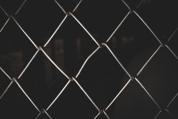 Fototapeta premium Silver wire mesh weave, black background