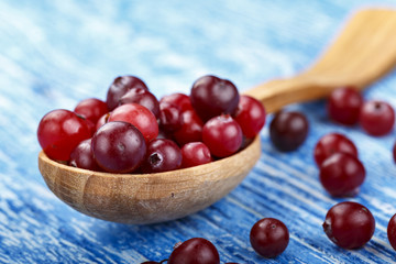 ripe cranberries in a spoon