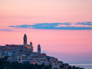 Aerial view Cervo medieval town on the mediterranean coast, Liguria riviera, Italy, with the beautiful baroque church and tower bells. Summer tourism in Italy.
