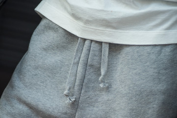 closeup of grey trousers and white tee shirt in sport wear store showroom