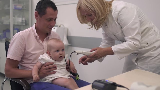 Nurse examines a baby