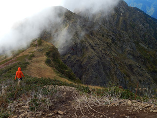 Girl tourist in the mountains. Mountain landscape. Hiking 