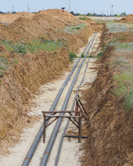 Technological pipelines DN50 and DN 150 make a turn by means of bends in the trench and approach...