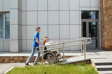 Woman in a wheelchair using a ramp