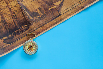 Vintage Compass and old sea map on color background.
