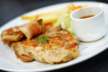 Bacon and meat stack on dish food background.