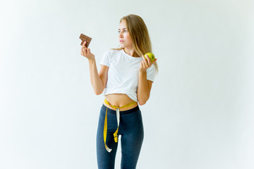 Fit woman measuring waist with measuring tape