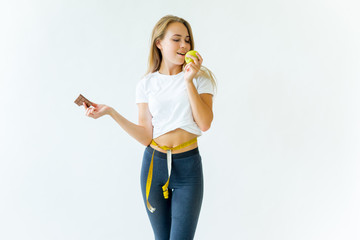 Fit woman measuring waist with measuring tape