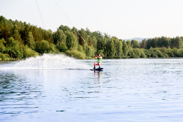 Young man riding wakeboard on a lake