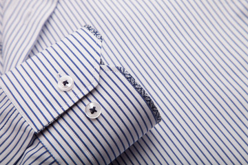 Fototapeta na wymiar Piece of cotton shirt. Pure cotton fabric. Classic men's shirt collar detail 