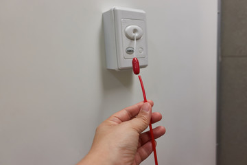 Pulling of red emergency call alert in the hospital toilet