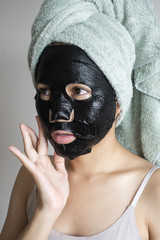 Beautiful woman with Black  facial mask, Lifestyle concept
