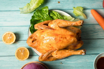 Roast chicken on the wooden table