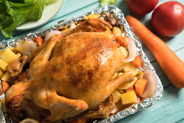 Roast chicken on the wooden table