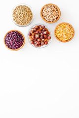 Vegan protein source. Legumes and nuts on white background top view copy space